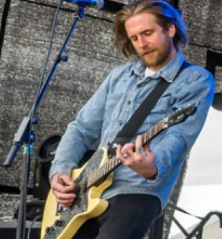 Gary playing guitar on stage
